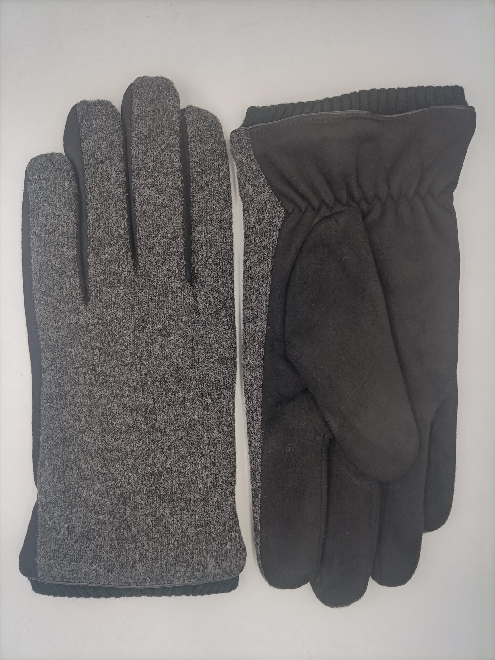 Hands using smartphone with fabric gloves